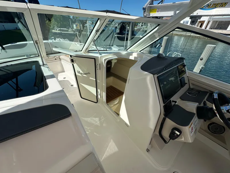 Slide: The Image of 2018 Boston Whaler 320 Vantage boat docked, featuring spacious seating and Garmin equipment. - 22