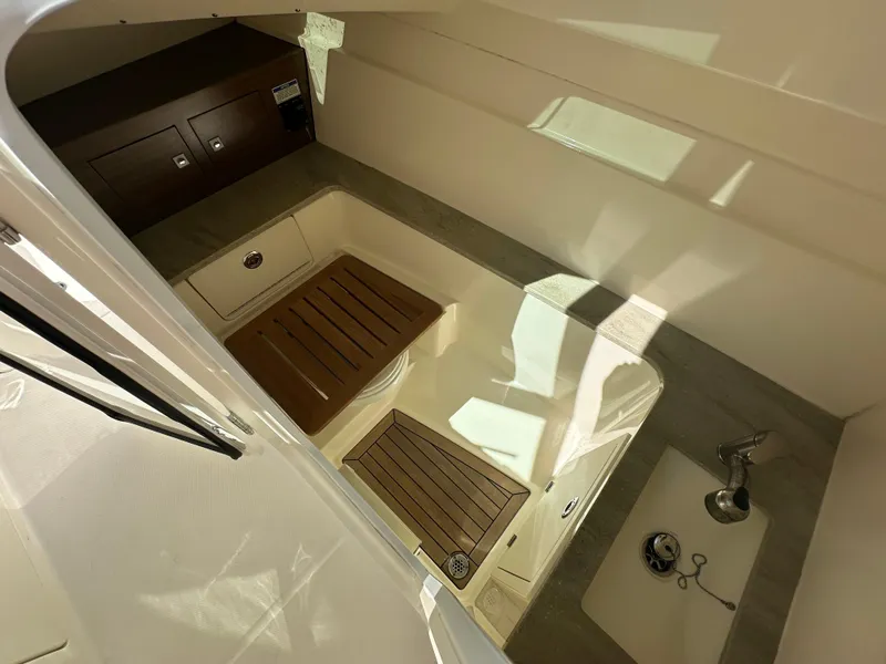 Slide: The Image of 2018 Boston Whaler 320 Vantage boat docked, featuring Garmin equipment and spacious seating. - 23