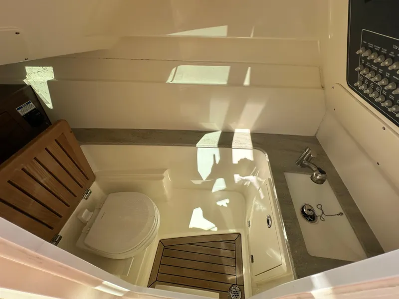 Slide: The Image of 2018 Boston Whaler 320 Vantage helm with modern controls and steering wheel. - 24