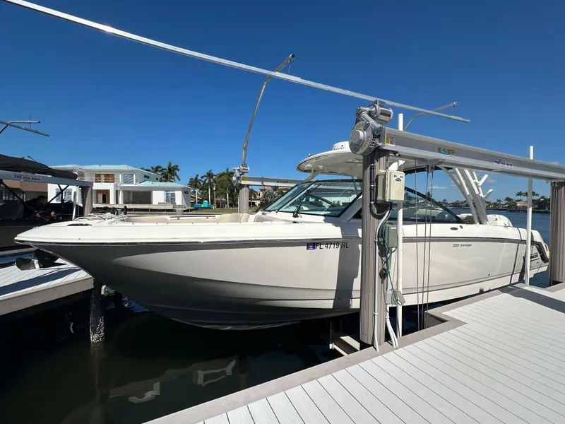 Slide: The Image of 2018 Boston Whaler 320 Vantage boat docked, featuring spacious seating and dual Verado engines. - 4