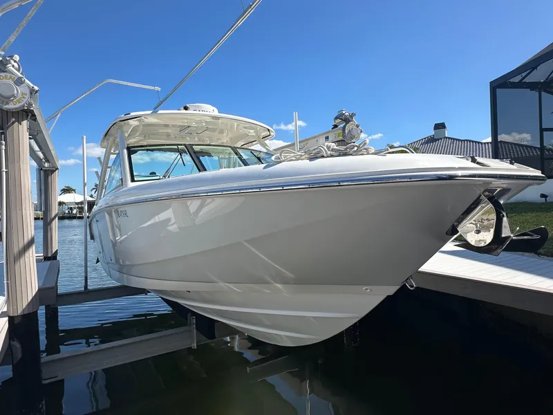 Slide: The Image of 2018 Boston Whaler 320 Vantage boat stern with dual outboard motors in water. - 9