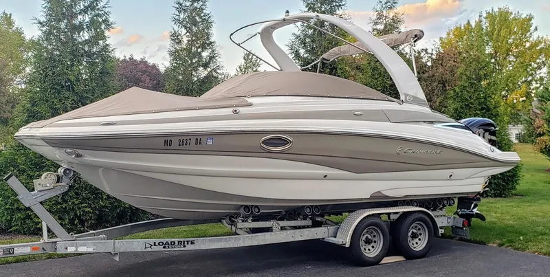 Slide: The Image of 2016 Crownline Eclipse E4 XS boat on trailer, parked outdoors. - 0