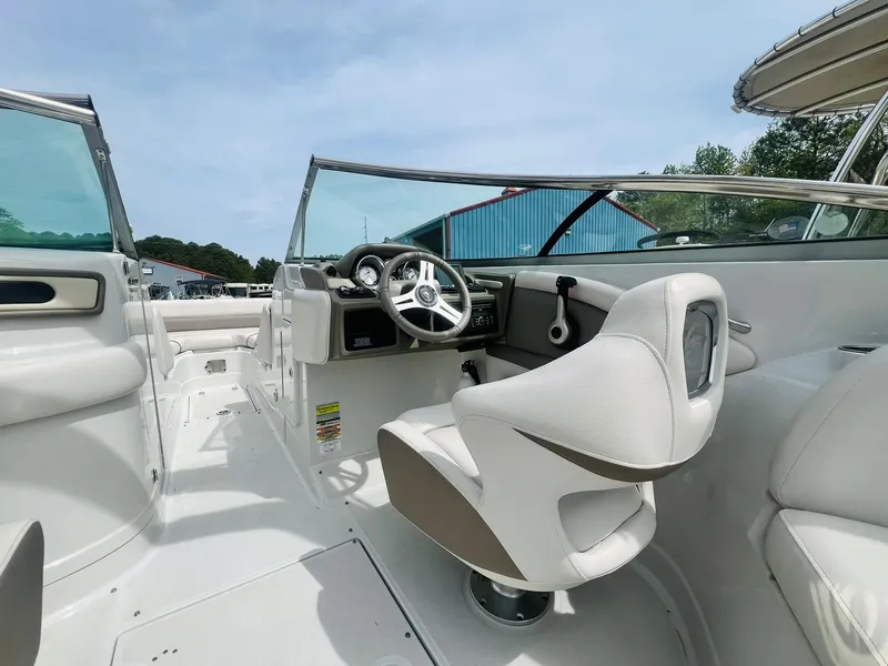 Slide: The Image of 2016 Crownline Eclipse E4 XS boat interior with steering wheel and seating. - 10