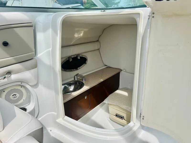 Slide: The Image of 2016 Crownline Eclipse E4 XS boat interior with sink and storage area. - 13
