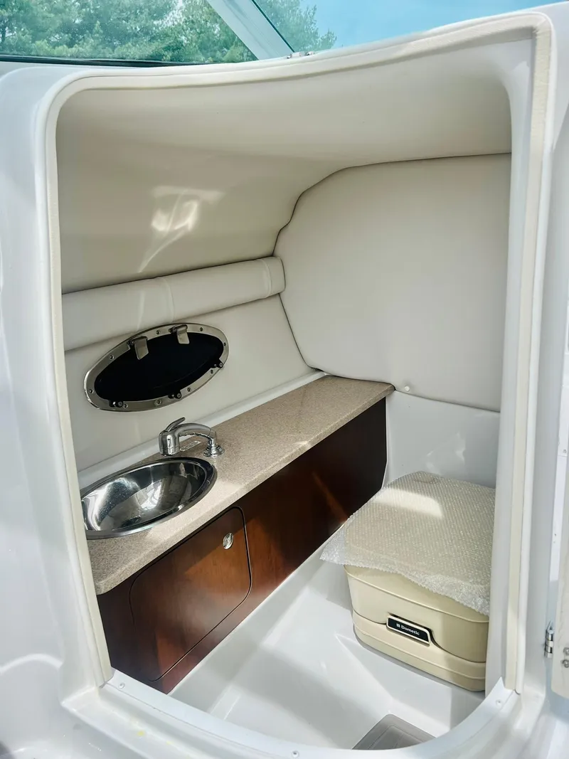 Slide: The Image of 2016 Crownline Eclipse E4 XS boat interior with sink and seating area. - 14