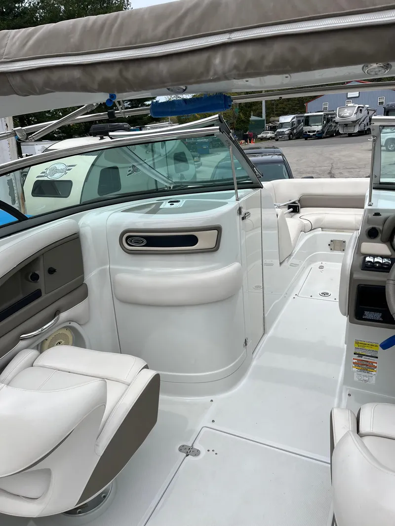 Slide: The Image of 2016 Crownline Eclipse E4 XS boat interior with white seating and dashboard. - 16