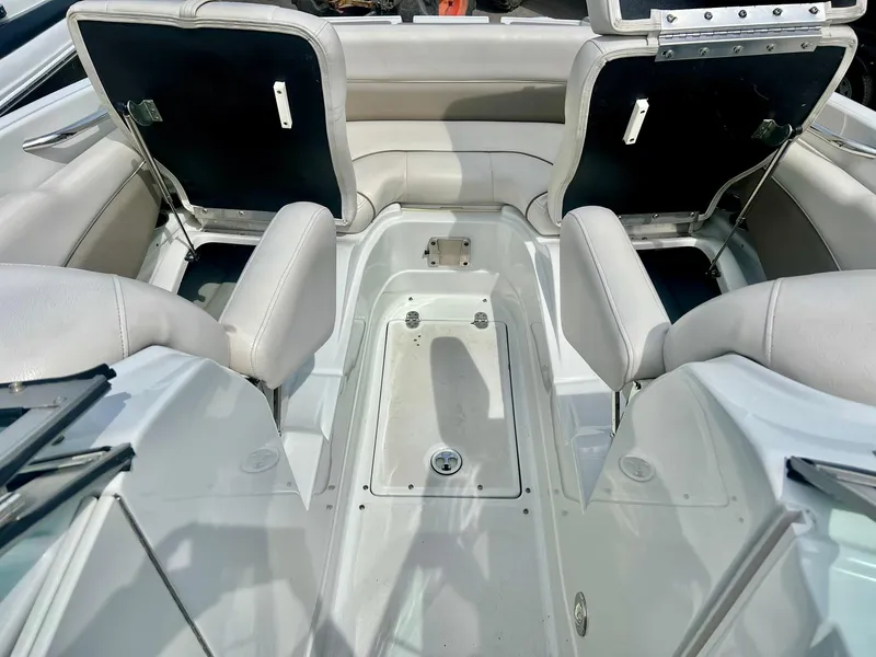 Slide: The Image of 2016 Crownline Eclipse E4 XS boat interior with white seating and storage compartments. - 19