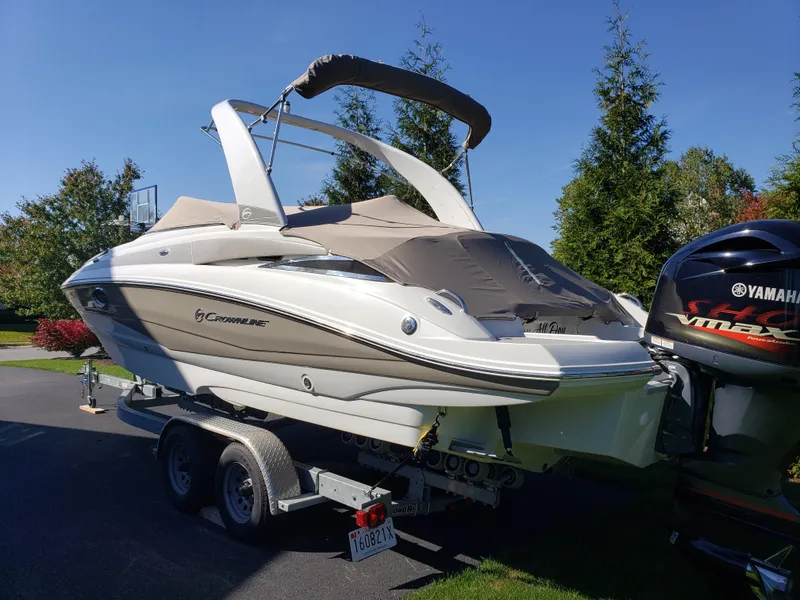 Slide: The Image of 2016 Crownline Eclipse E4 XS boat on trailer with Yamaha outboard motor. - 2