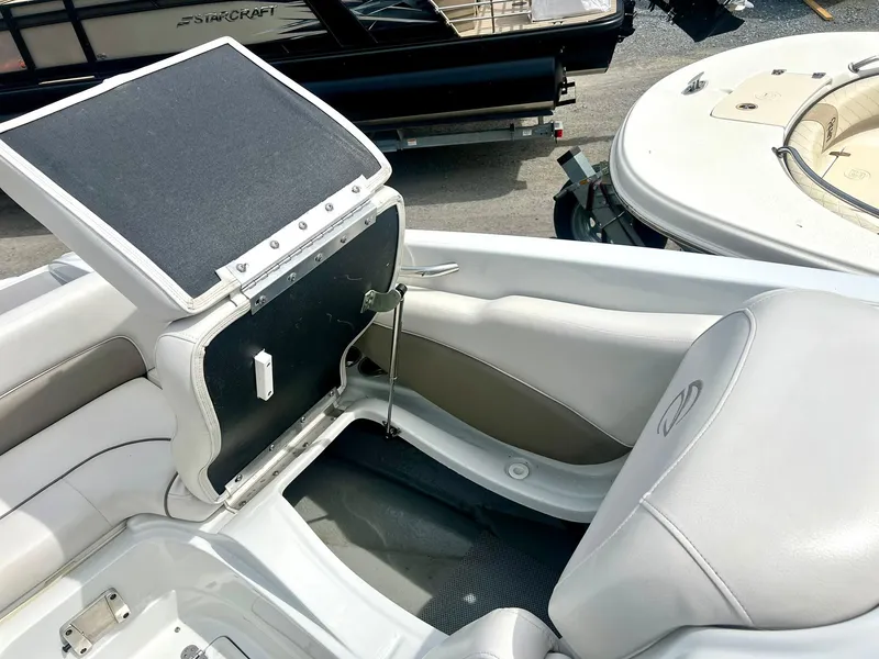 Slide: The Image of 2016 Crownline Eclipse E4 XS boat interior with open storage compartment. - 22