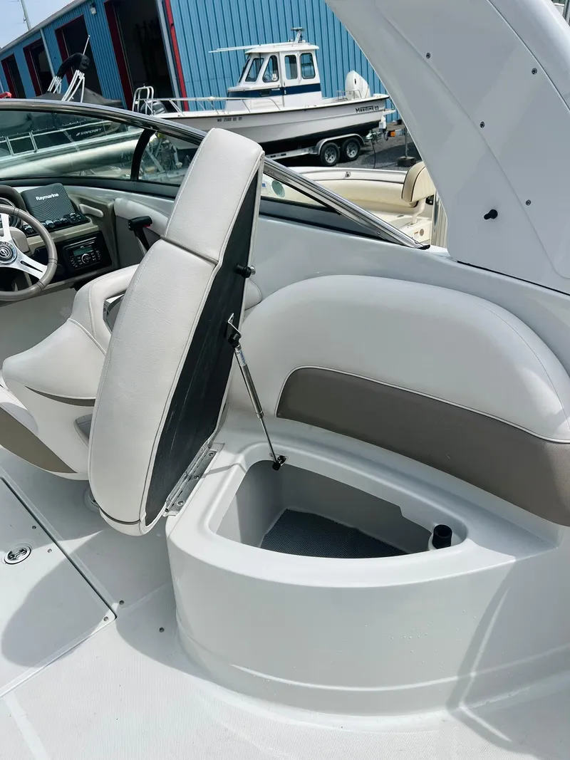 Slide: The Image of 2016 Crownline Eclipse E4 XS boat interior with open storage compartment. - 27