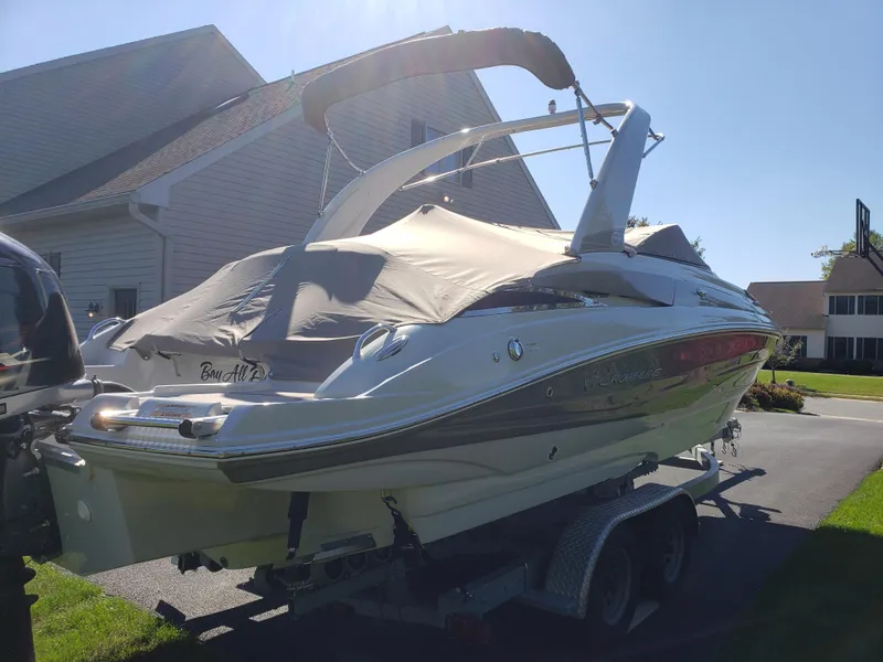 Slide: The Image of 2016 Crownline Eclipse E4 XS boat on trailer, covered and parked in driveway. - 3