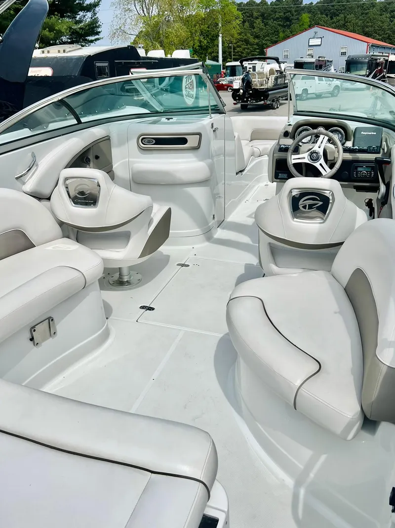 Slide: The Image of 2016 Crownline Eclipse E4 XS boat interior with white seating and steering wheel. - 34