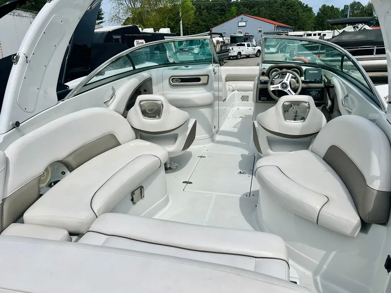 Slide: The Image of 2016 Crownline Eclipse E4 XS boat interior with white seating and modern dashboard. - 36