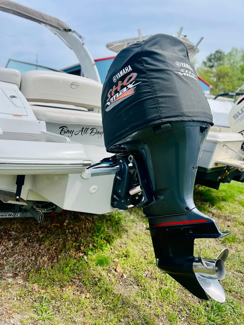 Slide: The Image of 2016 Crownline Eclipse E4 XS boat with Yamaha outboard motor, parked on grass. - 38