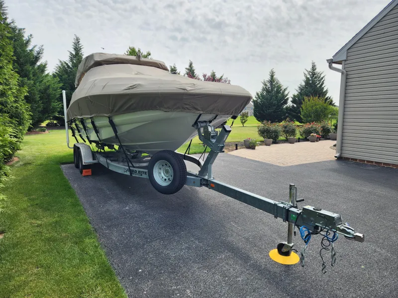 Slide: The Image of 2016 Crownline Eclipse E4 XS boat covered on trailer in driveway. - 4
