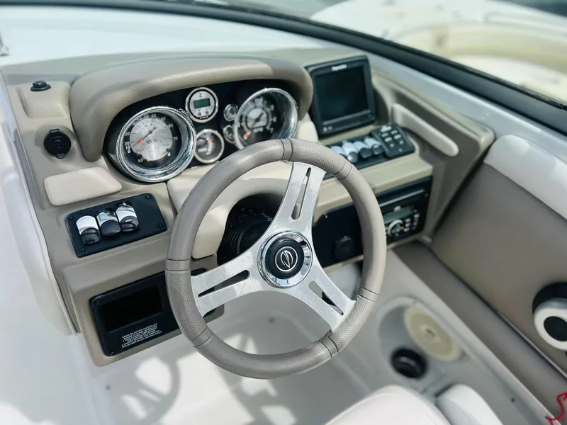 Slide: The Image of 2016 Crownline Eclipse E4 XS boat dashboard with steering wheel and gauges. - 7