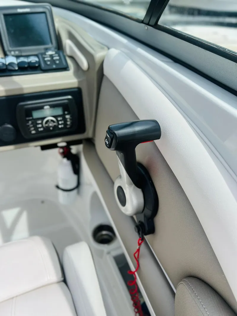 Slide: The Image of 2016 Crownline Eclipse E4 XS boat interior with control panel and throttle lever. - 9