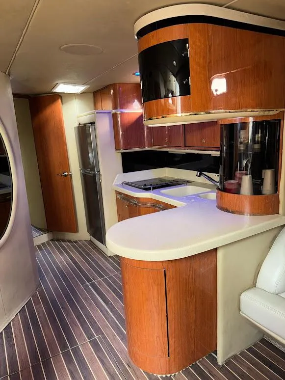 Slide: The Image of Luxurious 1998 Sea Ray 500 Sundancer yacht interior with modern kitchen and wood finishes. - 18
