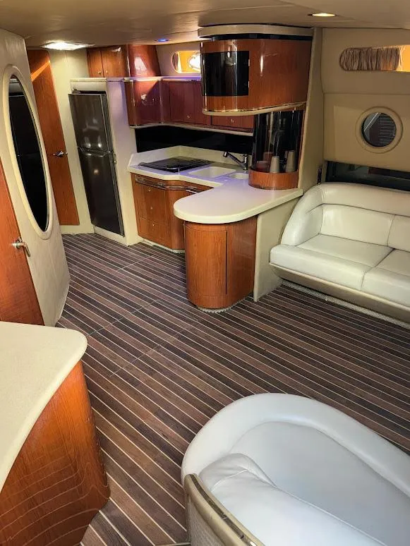 Slide: The Image of Interior of 1998 Sea Ray 500 Sundancer yacht with modern kitchen and seating area. - 19