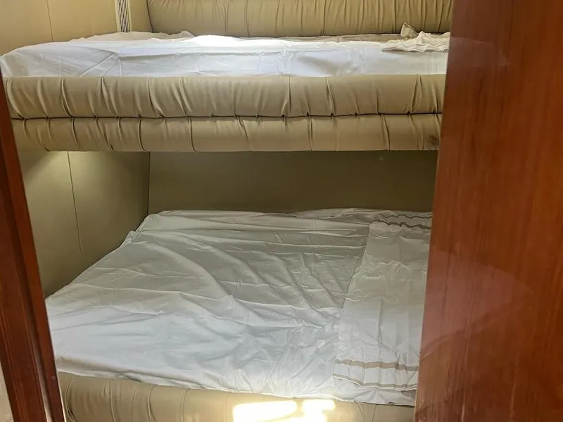 Slide: The Image of Bunk beds in 1998 Sea Ray 500 Sundancer yacht cabin, featuring beige upholstery. - 22
