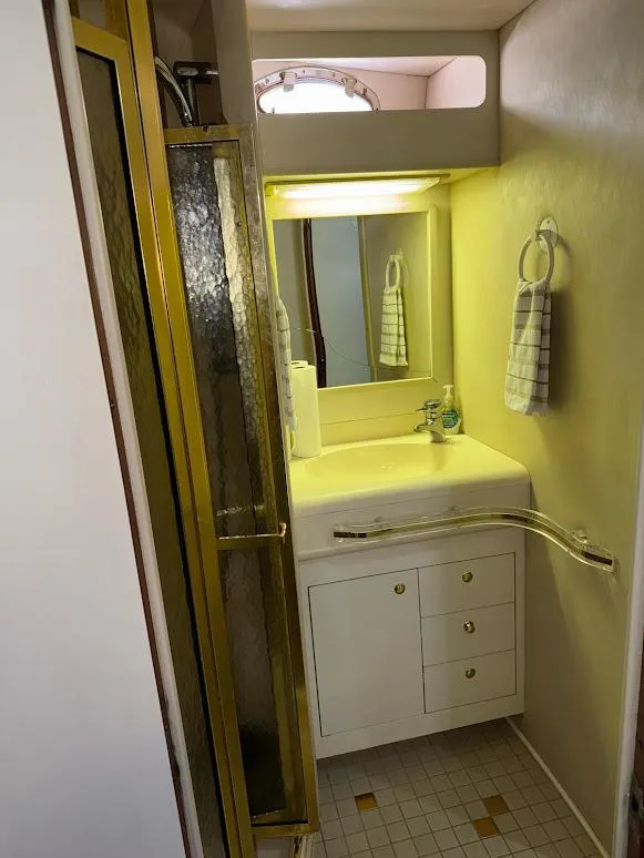 Slide: The Image of 1998 Sea Ray 500 Sundancer bathroom with shower, sink, and mirror. - 23