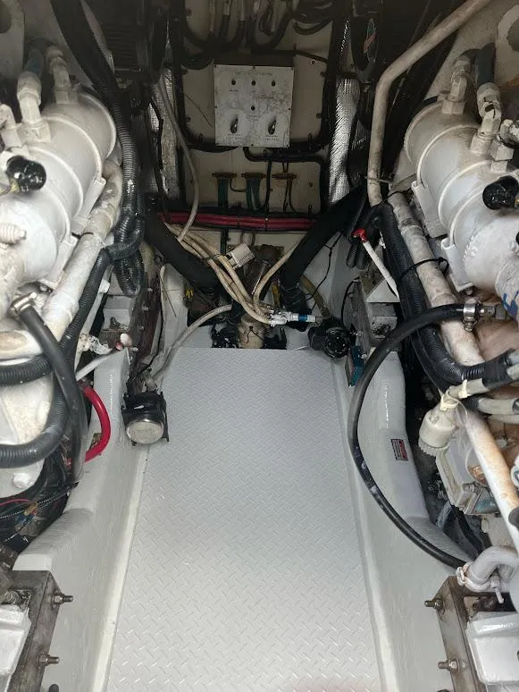 Slide: The Image of Engine room of a 1998 Sea Ray 500 Sundancer with visible machinery and wiring. - 28