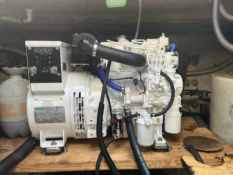 Slide: The Image of Engine compartment of a 1998 Sea Ray 500 Sundancer boat, showcasing mechanical components. - 29