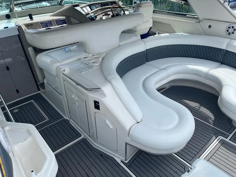 Slide: The Image of 1998 Sea Ray 500 Sundancer interior with curved seating and modern dashboard. - 6