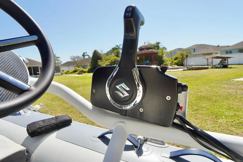 Slide: The Image of 2023 Highfield Classic 340 GT boat throttle control in a sunny outdoor setting. - 10