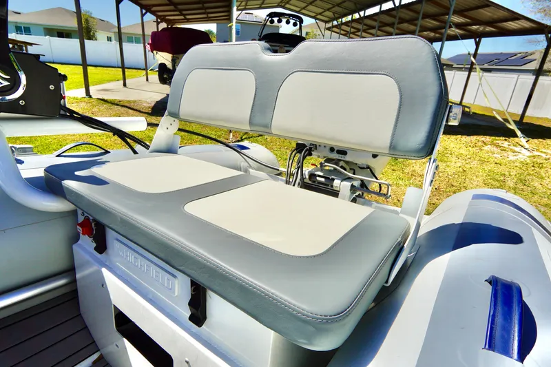 Slide: The Image of 2023 Highfield Classic 340 GT boat seat, featuring gray and white cushioned design. - 12