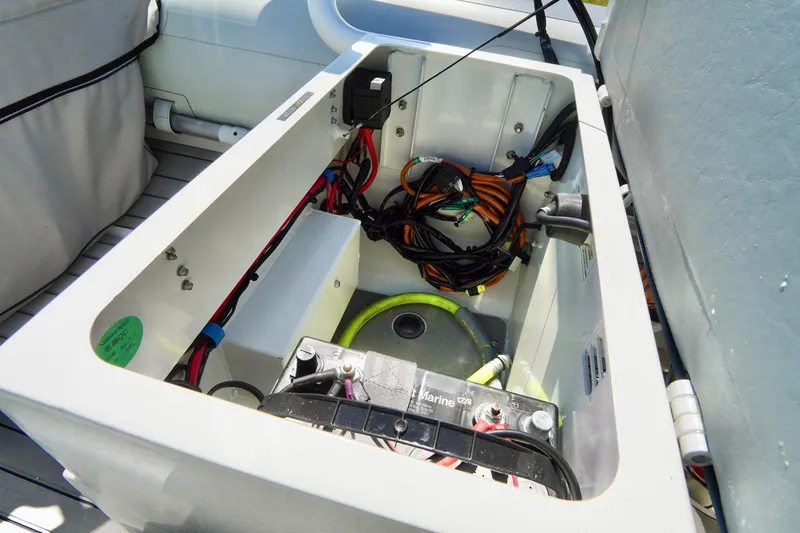 Slide: The Image of 2023 Highfield Classic 340 GT boat storage compartment with wiring and battery. - 13