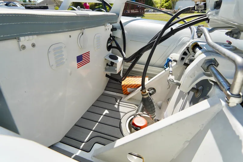Slide: The Image of 2023 Highfield Classic 340 GT boat interior with American flag sticker, showing seating and equipment. - 16