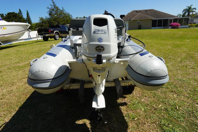 Slide: The Image of 2023 Highfield Classic 340 GT inflatable boat with Suzuki outboard motor on grass. - 20