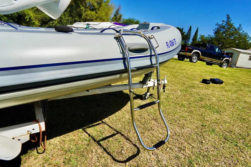 Slide: The Image of 2023 Highfield Classic 340 GT boat on trailer with ladder, parked on grass. - 7