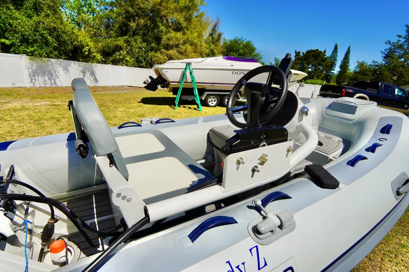 Slide: The Image of 2023 Highfield Classic 340 GT inflatable boat with steering console, parked on grass. - 8