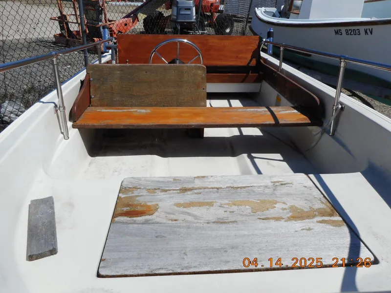 Slide: The Image of 1986 Boston Whaler 13 Super Sport interior with wooden seating and steering wheel. - 4