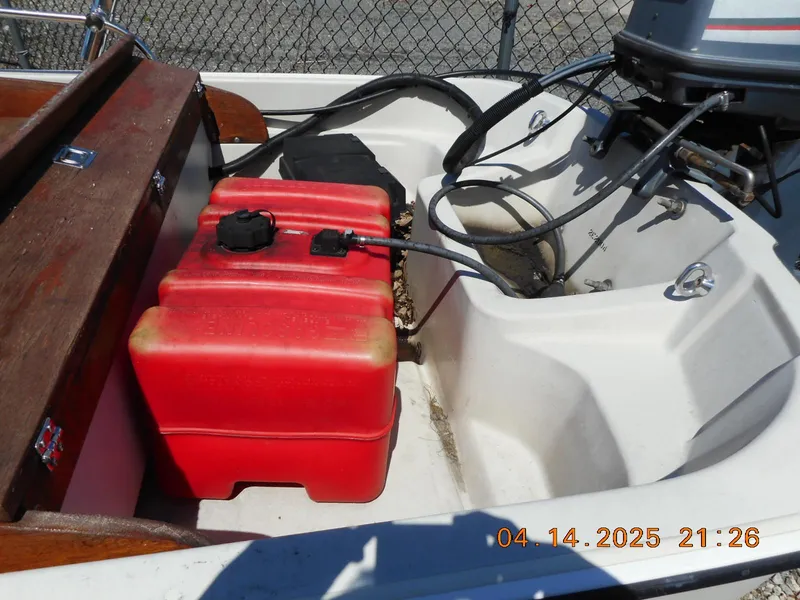 Slide: The Image of 1986 Boston Whaler 13 Super Sport boat with red fuel tank and outboard motor. - 6