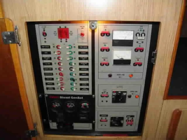 Slide: The Image of Electrical control panel on a 1983 Bertram Sportfisher boat, featuring switches and gauges. - 4