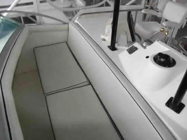 Slide: The Image of 1983 Bertram Sportfisher boat interior with seating and control panel. - 5