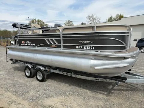 Slide: The Image of 2023 Sun Tracker Party Barge 20 DLX pontoon boat on trailer, parked outdoors. - 36