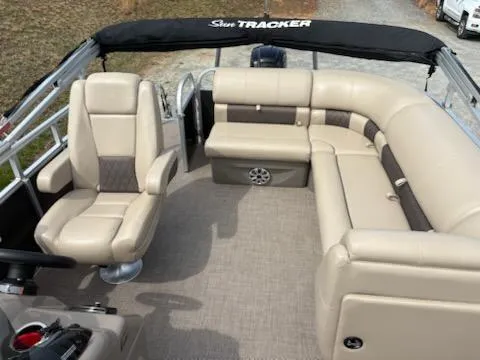 Slide: The Image of 2023 Sun Tracker Party Barge 20 DLX interior with beige seating and spacious layout. - 42