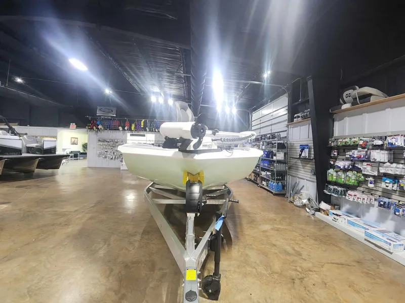 Slide: The Image of 2025 Xpress X23B Lounge boat displayed in a showroom with accessories. - 4