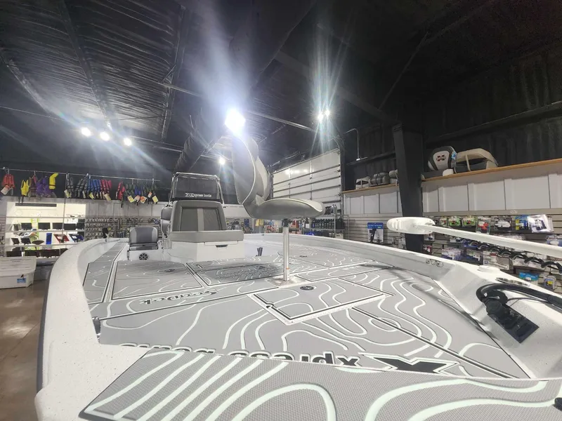 Slide: The Image of 2025 Xpress X23B Lounge boat in showroom, featuring sleek design and modern amenities. - 5