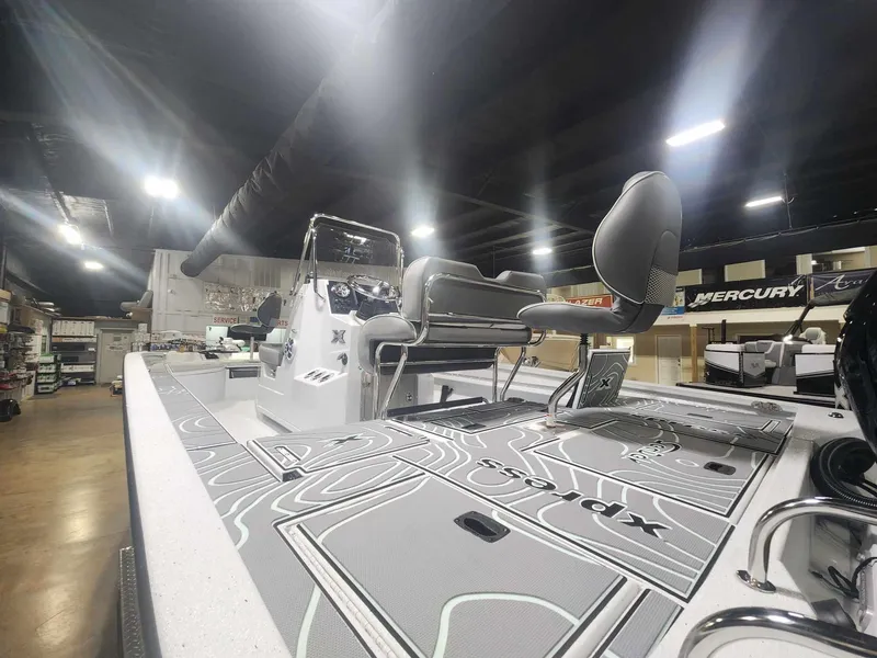 Slide: The Image of 2025 Xpress X23B Lounge boat interior with modern seating and sleek design. - 7