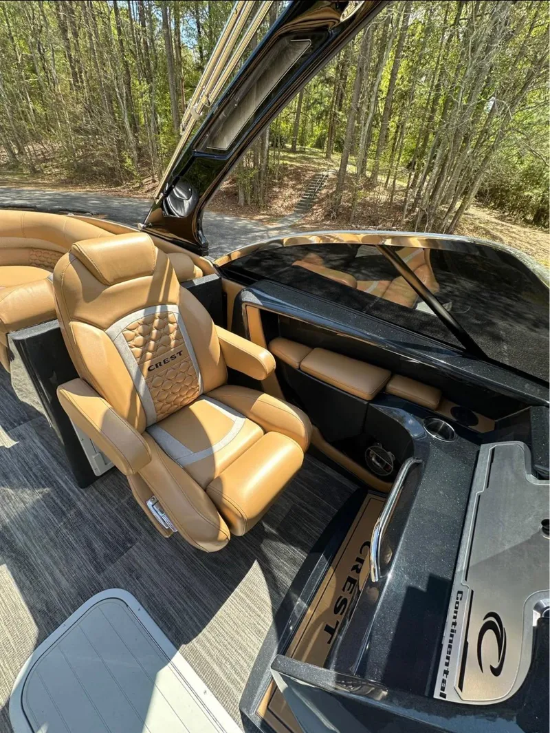 Slide: The Image of 2023 Crest Continental NX 270 boat interior with luxurious tan seating and sleek dashboard design. - 13