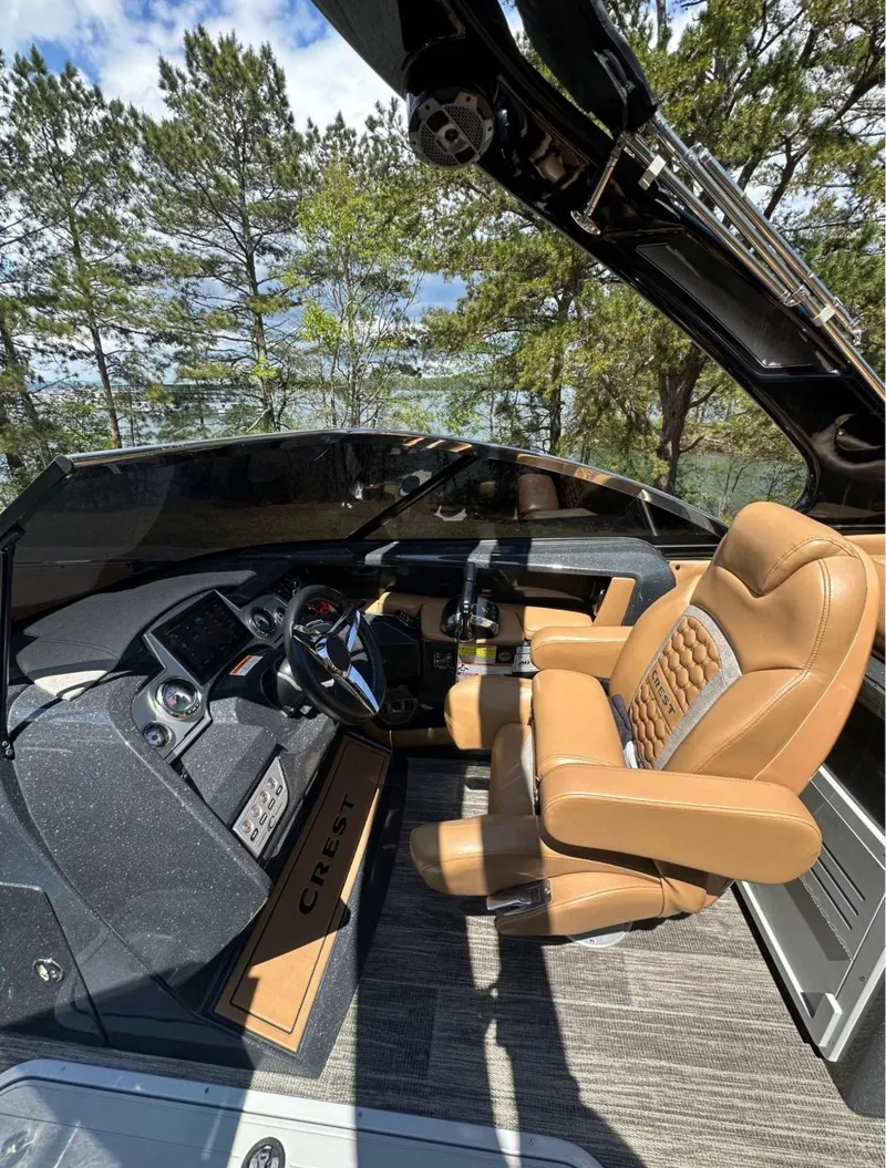 Slide: The Image of 2023 Crest Continental NX 270 boat interior with luxurious seating and modern dashboard. - 14