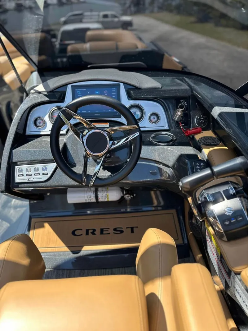 Slide: The Image of 2023 Crest Continental NX 270 boat dashboard with steering wheel and controls. - 3