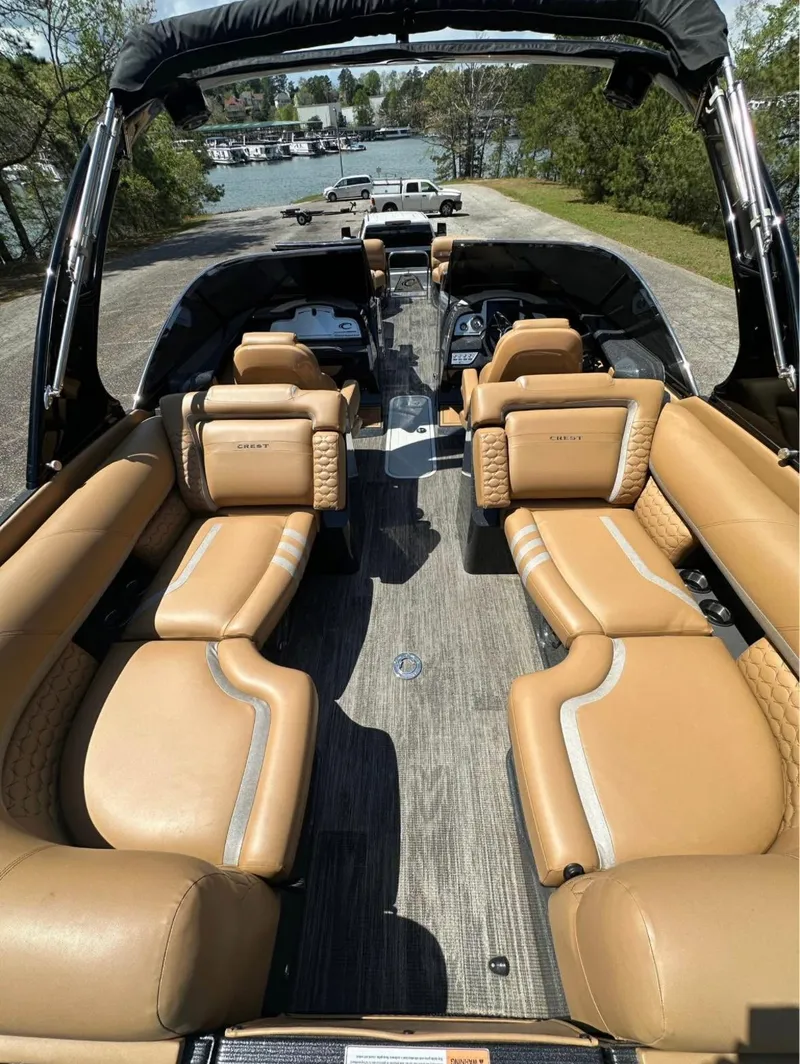 Slide: The Image of 2023 Crest Continental NX 270 boat with luxurious tan seating and spacious interior. - 8