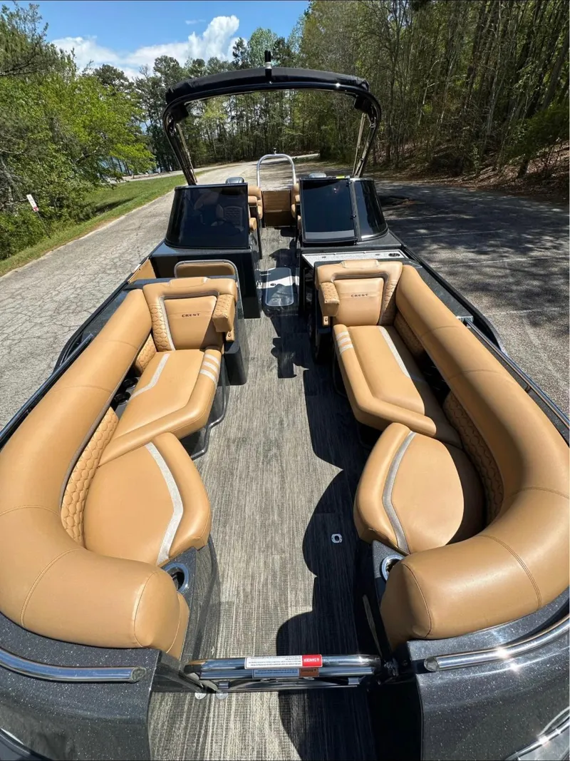 Slide: The Image of 2023 Crest Continental NX 270 boat interior with luxurious tan seating and sleek design. - 9