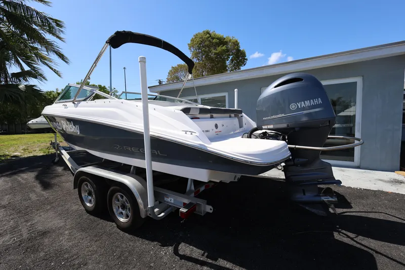 Slide: The Image of 2022 Regal 21 OBX boat with Yamaha outboard motor on a trailer. - 18